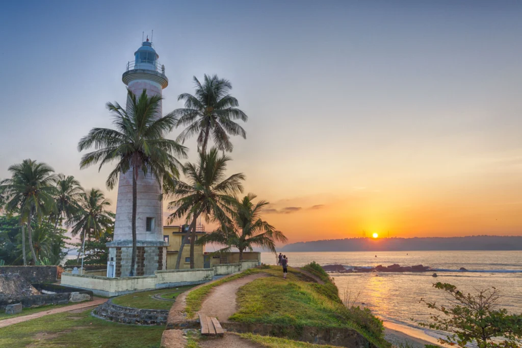 Galle Fort Lighthouse at sunset in Sri Lanka overlooking the Indian Ocean and UNESCO heritage fort