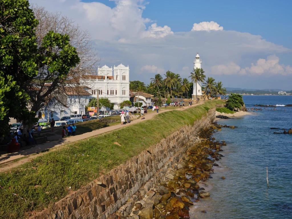 Galle Fort Lighthouse overlooking the historic ramparts and Indian Ocean in Galle, Sri Lanka.