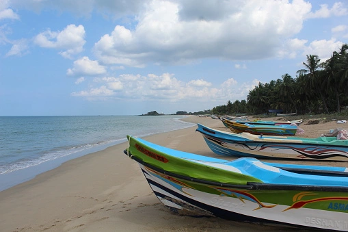 Colourful traditional fishing boats along the sandy coast near Nilaveli Beach in Trincomalee