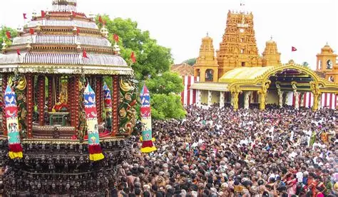 Large crowds gathered around a decorated ceremonial chariot during the Nallur Kandaswamy Temple festival in Jaffna, Sri Lanka.