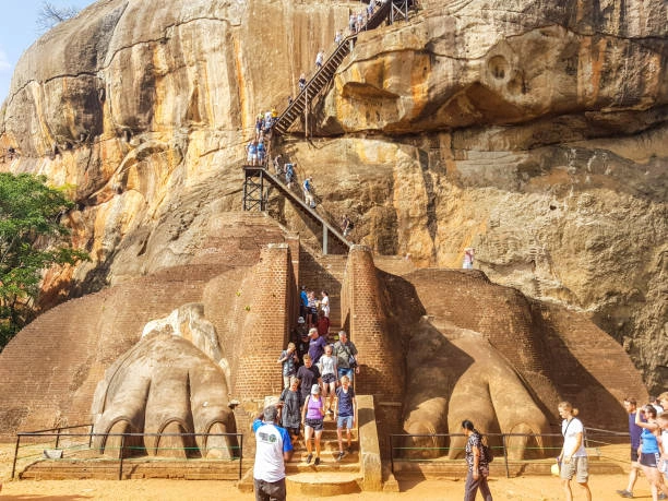 Visitors climbing the historic Lion’s Paw staircase at Sigiriya Rock Fortress in Sri Lanka.