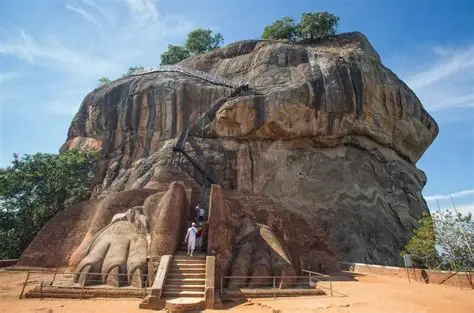 Sigiriya Rock Fortress with the ancient Lion’s Paw entrance and staircase at its base in Sri Lanka.